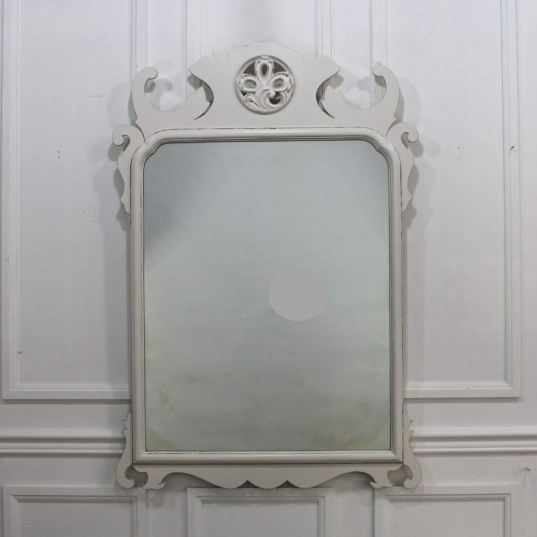 Wooden mirror with medallion at top