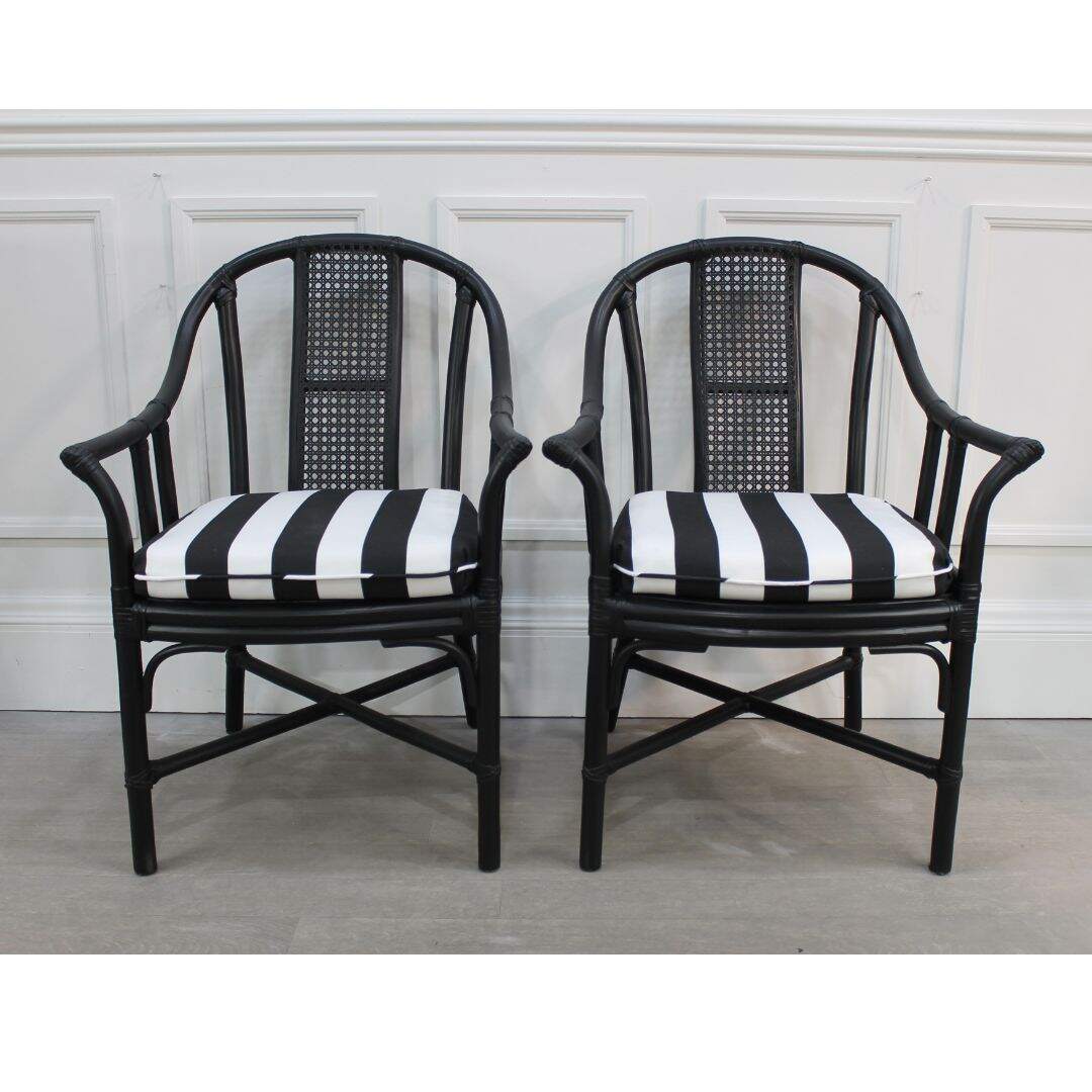 Pair of black bamboo chairs with caning